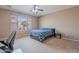 Bright bedroom with large window, plush carpeting, ceiling fan and ample natural light at 3458 E Ivanhoe St, Gilbert, AZ 85295