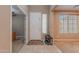 Bright foyer with neutral walls, tile flooring, and a bench with shoe storage, enhancing its welcoming ambiance at 3458 E Ivanhoe St, Gilbert, AZ 85295