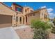Inviting front exterior with well-manicured landscaping, arched entryway, and a two-car garage at 3458 E Ivanhoe St, Gilbert, AZ 85295