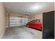Attached two car garage featuring an automatic door and a parked red car at 3458 E Ivanhoe St, Gilbert, AZ 85295