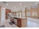 Open kitchen featuring a stainless steel refrigerator, granite island, and modern fixtures, creating an inviting space at 3458 E Ivanhoe St, Gilbert, AZ 85295