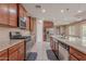Stylish kitchen featuring stainless steel appliances, granite countertops, and rich wood cabinetry, perfect for cooking and entertaining at 3458 E Ivanhoe St, Gilbert, AZ 85295