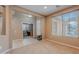 Bright living room with a large window, neutral walls, carpet, and a view of the foyer and office space at 3458 E Ivanhoe St, Gilbert, AZ 85295