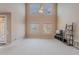 Bright living room boasts high ceilings, oversized windows with natural light, and neutral carpeting at 3458 E Ivanhoe St, Gilbert, AZ 85295