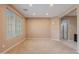 Spacious living room with neutral walls, carpet, recessed lighting, and a large window filling the room with natural light at 3458 E Ivanhoe St, Gilbert, AZ 85295