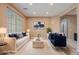 Staged living room featuring modern furniture, plush rug, and ample natural light, perfect for relaxation and entertaining at 3458 E Ivanhoe St, Gilbert, AZ 85295