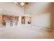 Open floor plan with a view of the kitchen featuring an island with bar stools, stainless steel appliances, and wooden cabinets at 3458 E Ivanhoe St, Gilbert, AZ 85295