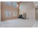 Bright living room with high ceilings, ample windows, and neutral carpet, perfect for relaxation at 3458 E Ivanhoe St, Gilbert, AZ 85295