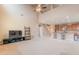 Large living room view with an open floor plan, staircase, and kitchen with a breakfast bar at 3458 E Ivanhoe St, Gilbert, AZ 85295
