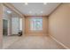 Open-concept living room with neutral walls, carpet, and natural light from the window creating a comfortable space at 3458 E Ivanhoe St, Gilbert, AZ 85295