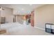 Living room has an open floor plan with kitchen view, breakfast bar, stainless steel appliances, and tile flooring at 3458 E Ivanhoe St, Gilbert, AZ 85295