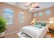 This bedroom provides ample natural light, neutral colors, and a ceiling fan at 3458 E Ivanhoe St, Gilbert, AZ 85295