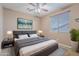 Cozy main bedroom with a ceiling fan, natural light, and plush carpeting at 3458 E Ivanhoe St, Gilbert, AZ 85295