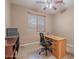 Cozy home office featuring a functional desk, carpet, ceiling fan, and a window creating a productive workspace at 3458 E Ivanhoe St, Gilbert, AZ 85295