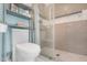 Bathroom featuring a tile shower and a modern commode with shelving at 3500 N Hayden Rd # 2110, Scottsdale, AZ 85251