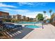 Community pool and spa area featuring comfortable lounge chairs under sunny blue skies at 3500 N Hayden Rd # 2110, Scottsdale, AZ 85251