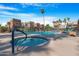 Resort-style pool and spa with lounge chairs, palm trees, and beautifully maintained landscaping at 3500 N Hayden Rd # 2110, Scottsdale, AZ 85251