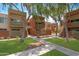 Exterior view of multiple units with well-maintained landscaping and mature shade trees in a courtyard setting at 3500 N Hayden Rd # 2110, Scottsdale, AZ 85251