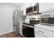 Modern kitchen with stainless steel appliances, white cabinetry, and sleek countertops at 3500 N Hayden Rd # 2110, Scottsdale, AZ 85251