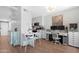 Cozy living area with dining table, adjacent workspace, and wood-look flooring at 3500 N Hayden Rd # 2110, Scottsdale, AZ 85251