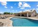 Lush backyard featuring a sparkling pool, outdoor seating, and covered patio area perfect for entertaining at 3658 E Pony Track Ln, San Tan Valley, AZ 85140