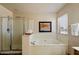 Bathroom featuring a glass shower and a separate bathtub with a window view at 3658 E Pony Track Ln, San Tan Valley, AZ 85140