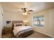 This bedroom features a ceiling fan, window, and light oak furniture at 3658 E Pony Track Ln, San Tan Valley, AZ 85140