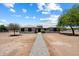 Expansive single-story home with a tile roof, desert landscaping, and a long stone walkway leading to the entrance at 3658 E Pony Track Ln, San Tan Valley, AZ 85140