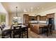Bright kitchen featuring an island with seating, a dining area, and wood cabinets offering ample storage at 3658 E Pony Track Ln, San Tan Valley, AZ 85140