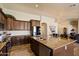 Well-equipped kitchen featuring a large island, granite countertops, stainless steel appliances and wood cabinetry at 3658 E Pony Track Ln, San Tan Valley, AZ 85140