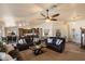 Open-concept living area with a ceiling fan, couches, and decor that seamlessly connects to the kitchen at 3658 E Pony Track Ln, San Tan Valley, AZ 85140
