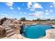 Gorgeous pool with a rock waterfall feature, perfect for outdoor entertaining and relaxation at 3658 E Pony Track Ln, San Tan Valley, AZ 85140