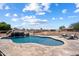 Sparkling pool with rock waterfall and lounge chairs set amidst a sprawling outdoor space at 3658 E Pony Track Ln, San Tan Valley, AZ 85140