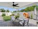 Cozy covered patio with pavers, ceiling fan, outdoor seating, and a charming playhouse in the landscaped backyard at 4215 E Flower St, Phoenix, AZ 85018