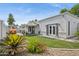 Wide backyard showcasing the covered patio, landscaped areas, and the home's exterior with French doors at 4215 E Flower St, Phoenix, AZ 85018