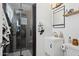This bathroom has a modern glass shower, black accents, and a floating vanity at 4215 E Flower St, Phoenix, AZ 85018