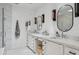 Bright bathroom with and sinks, white cabinets, quartz counters and black hardware at 4215 E Flower St, Phoenix, AZ 85018
