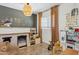 A bedroom features neutral paint, wood floors, play furniture, and an oversized window at 4215 E Flower St, Phoenix, AZ 85018