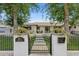 Charming home exterior featuring a black iron gate, manicured landscaping, and inviting front entrance at 4215 E Flower St, Phoenix, AZ 85018
