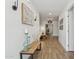 Bright hallway with wood flooring, decorative artwork, and stylish lighting fixtures at 4215 E Flower St, Phoenix, AZ 85018