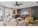 Comfortable living room with a large TV, stylish furniture, and access to the patio at 4215 E Flower St, Phoenix, AZ 85018