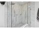 The primary bath features a luxurious shower with marble walls, glass doors, and dual shower heads at 4215 E Flower St, Phoenix, AZ 85018