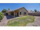 Cozy backyard features a covered patio and a compact grass area bordered by gravel landscaping at 4248 E Jason Dr, Phoenix, AZ 85050