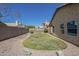 A charming backyard has a small lawn surrounded by rock landscaping and a block wall at 4248 E Jason Dr, Phoenix, AZ 85050