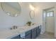 Bathroom featuring double sinks, quartz counters, gold fixtures, and wood-look tile at 4248 E Jason Dr, Phoenix, AZ 85050