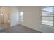 Light-filled bedroom featuring new carpet, white walls, and two bright windows at 4248 E Jason Dr, Phoenix, AZ 85050