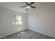 Carpeted bedroom featuring new paint, a window, and a ceiling fan at 4248 E Jason Dr, Phoenix, AZ 85050