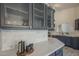 Kitchen with quartz countertops and backsplash plus glass door cabinets at 4248 E Jason Dr, Phoenix, AZ 85050