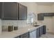Bright kitchen boasts stainless steel appliances, white quartz countertops, and grey cabinets at 4248 E Jason Dr, Phoenix, AZ 85050