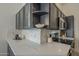 Modern kitchen featuring stainless steel appliances, white countertops, and grey cabinets at 4248 E Jason Dr, Phoenix, AZ 85050